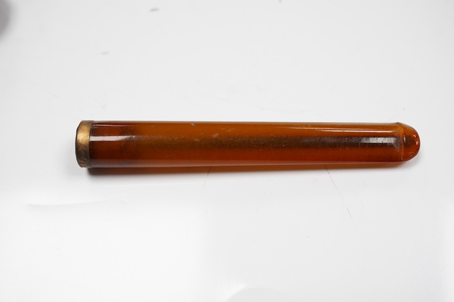 Three assorted cased cigarette holders, including amber, largest 10.1cm. Condition - fair